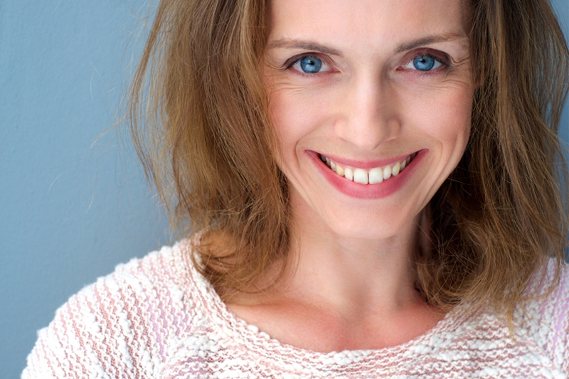 Close up portrait of an older woman smiling.