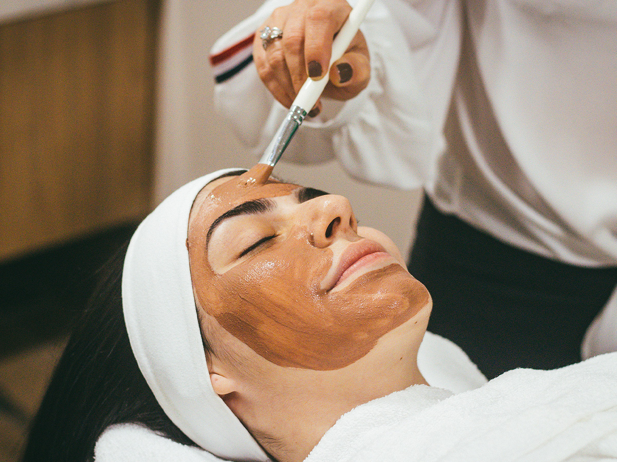 person getting mud facial