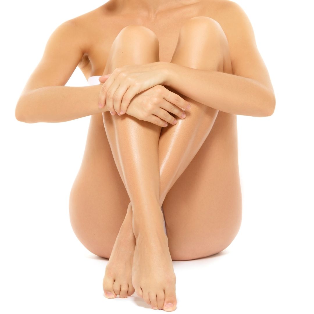 Woman in bikini sitting with ankles crossed