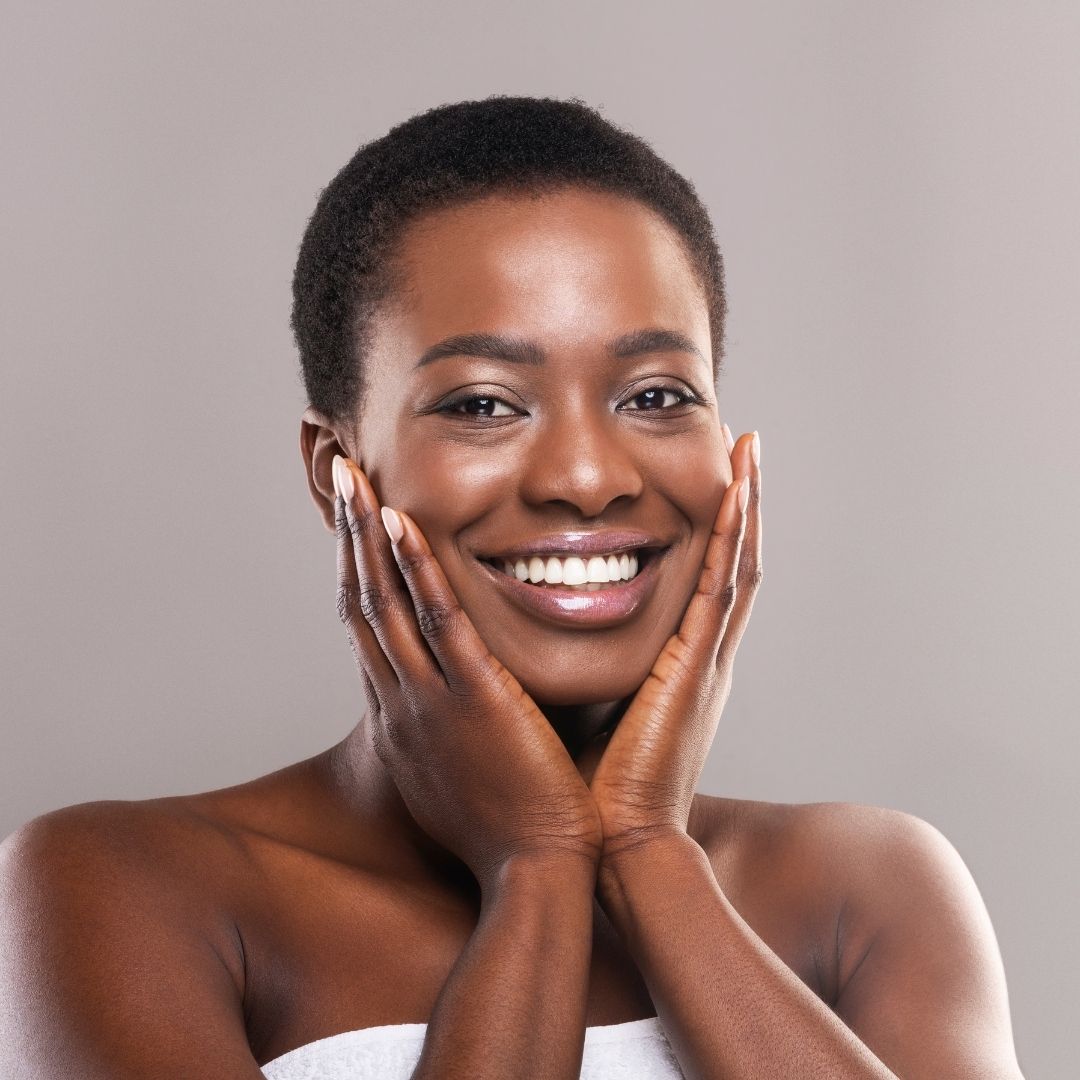 Beautiful woman smiling and holding her face