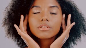Beautiful black woman touching her face