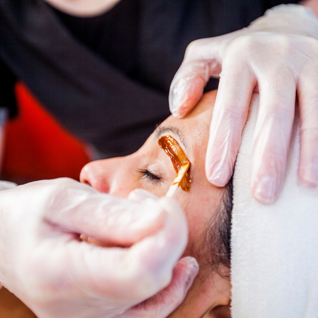 woman getting her eyebrows waxed