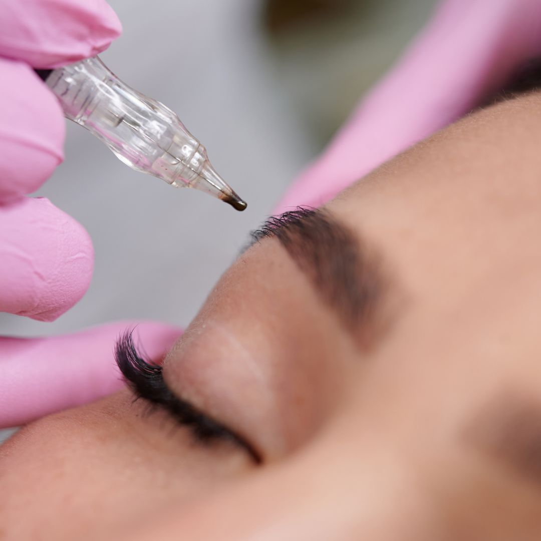 Woman having her eyebrows microbladed.