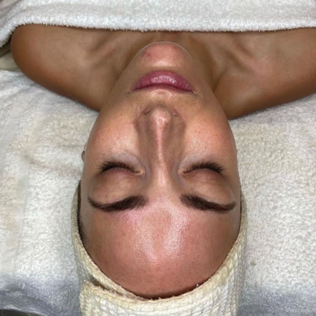 a person with a clean face laying in a spa